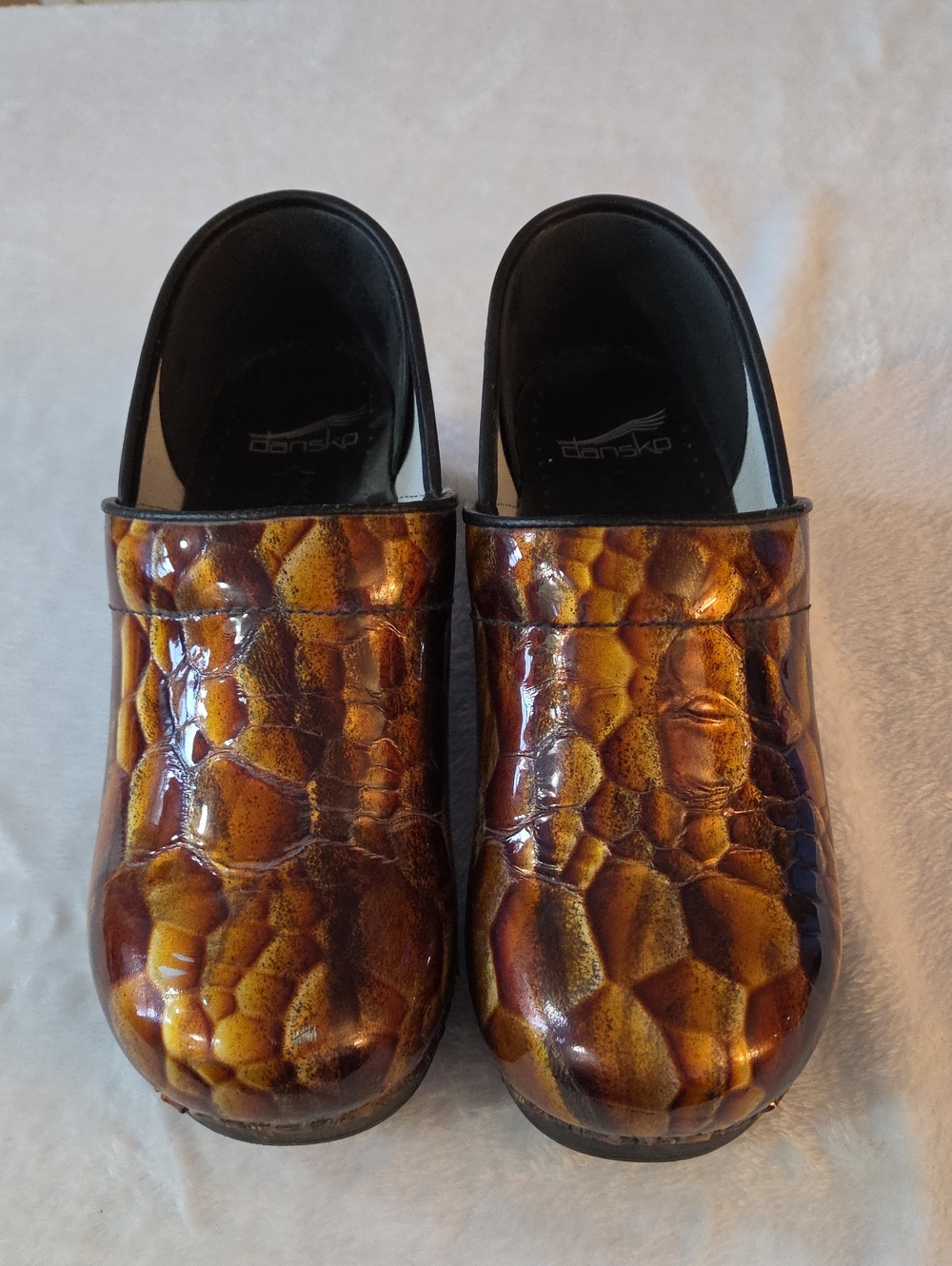 Dansko Menโs Brown and Gold Patent Leather Slip-On Clogs
